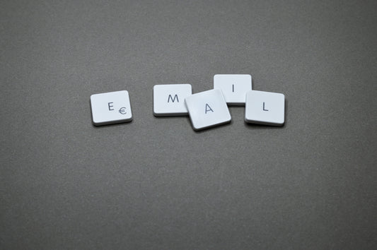 The word email is spelled out with letter tiles.